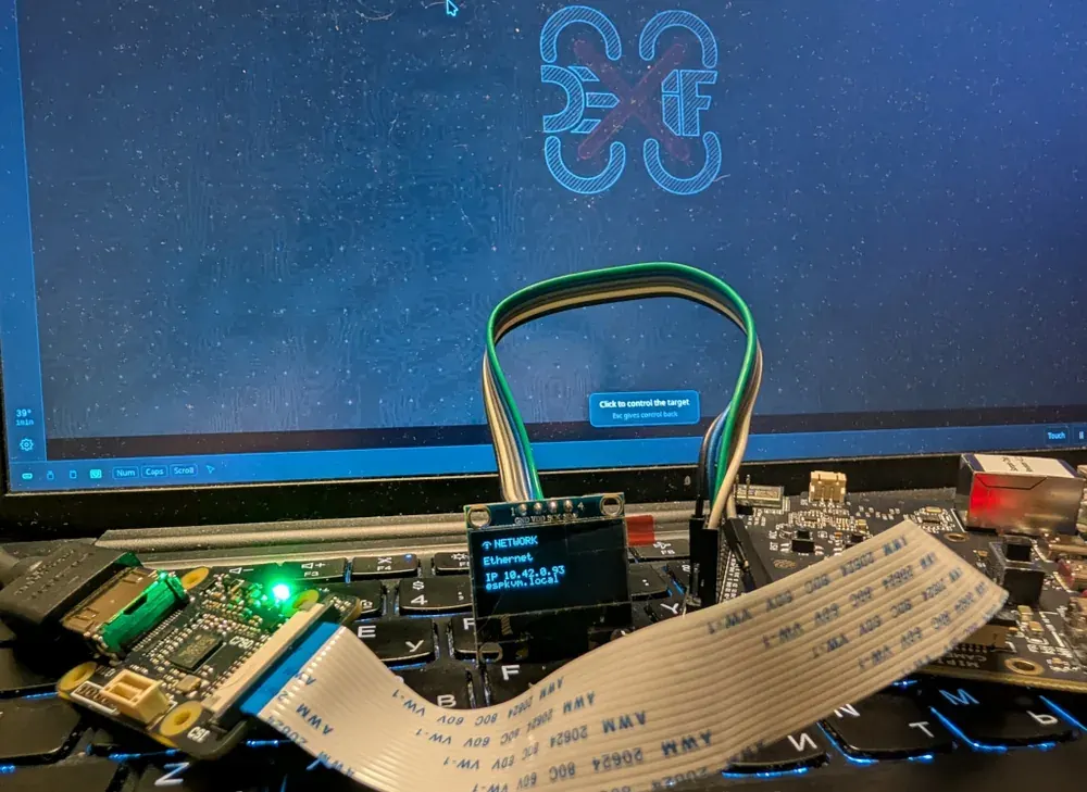 A 128x64 mono OLED soldered to the capture chip's I2C bus, showing the network page: the link it is on, its address, and the name it answers to.