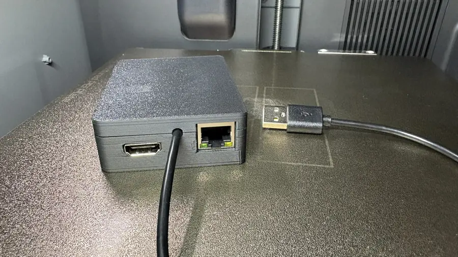 A 3D-printed case holding the ESP32-P4-ETH and the C790, with HDMI, Ethernet and the USB cable coming out of one side